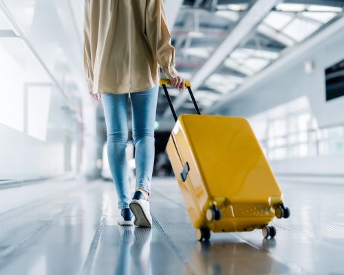 International,Airport,Terminal.,Asian,Beautiful,Woman,With,Luggage,And,Walking